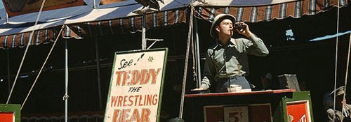 Colour photo of a barker at a fairground